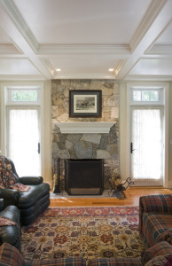 stone fireplace and wood coffered ceiling